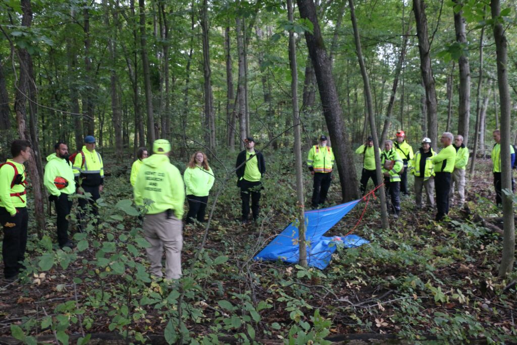 A tarp and some rope become a temporary shelter.